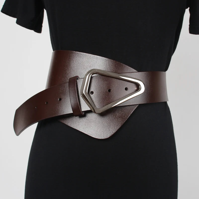 Close-up of geometric buckle on wide leather belt