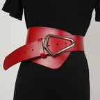 Asymmetric wide belt worn over a dress