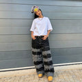 Pantalon en jean streetwear patchwork noir et gris à ourlet brut